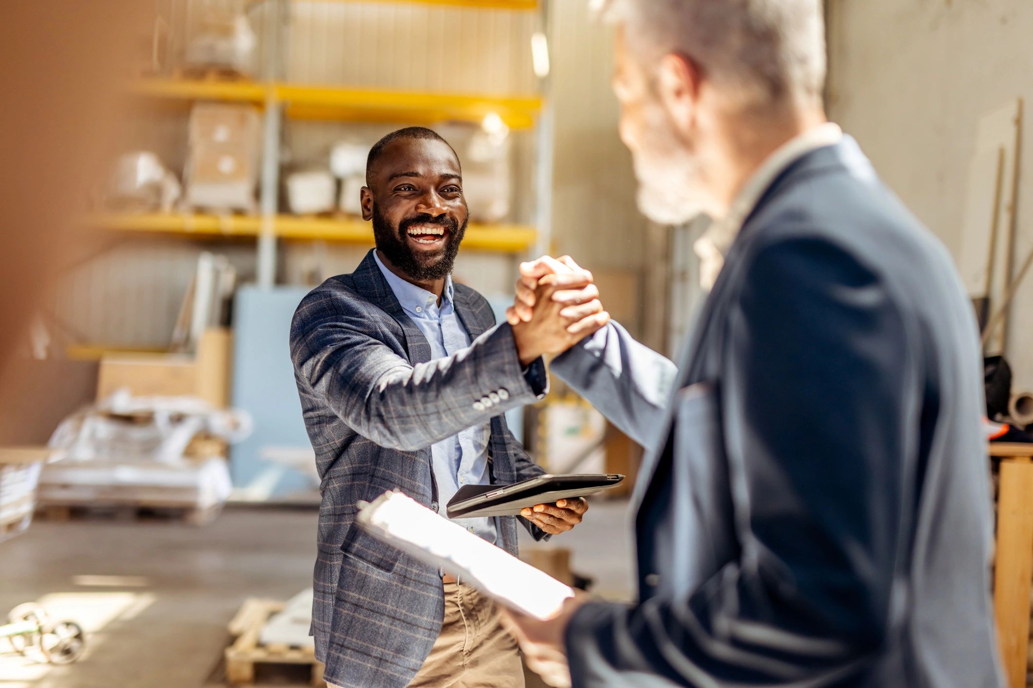 Business professionals shaking hands after reaching agreement