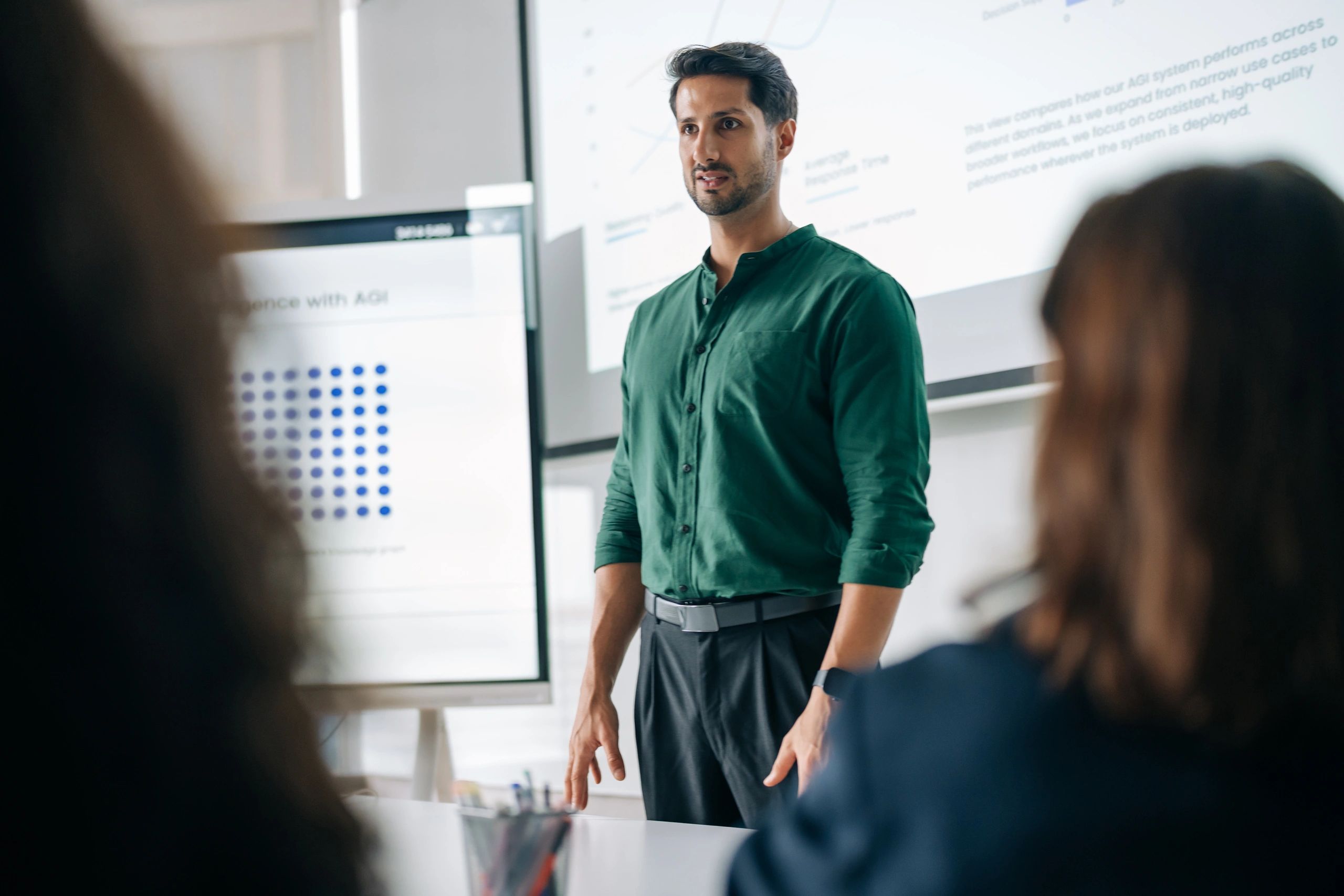 Executive leading a business review meeting after an acquisition